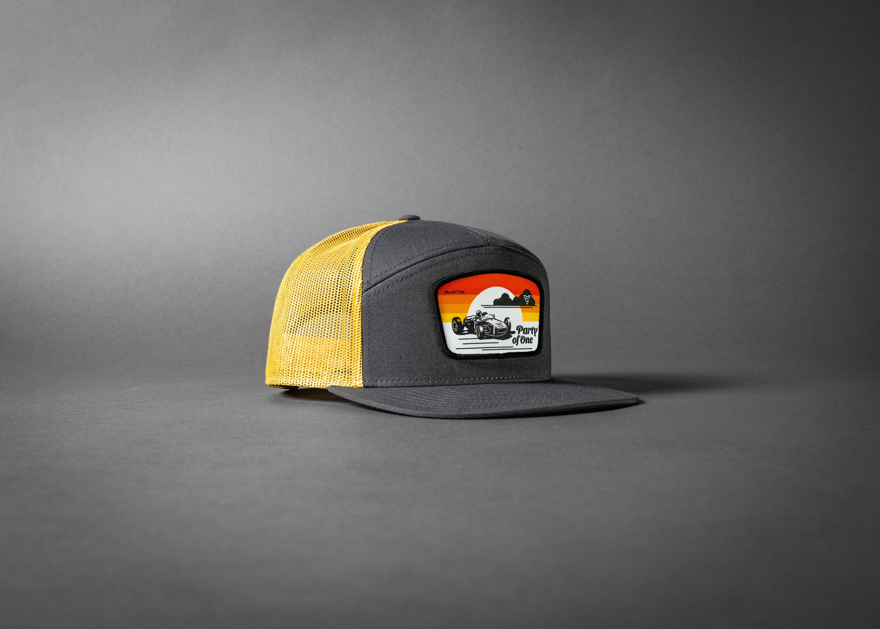 PARTY OF ONE (Charcoal/Old Gold Premium 7-Panel Trucker Hat)