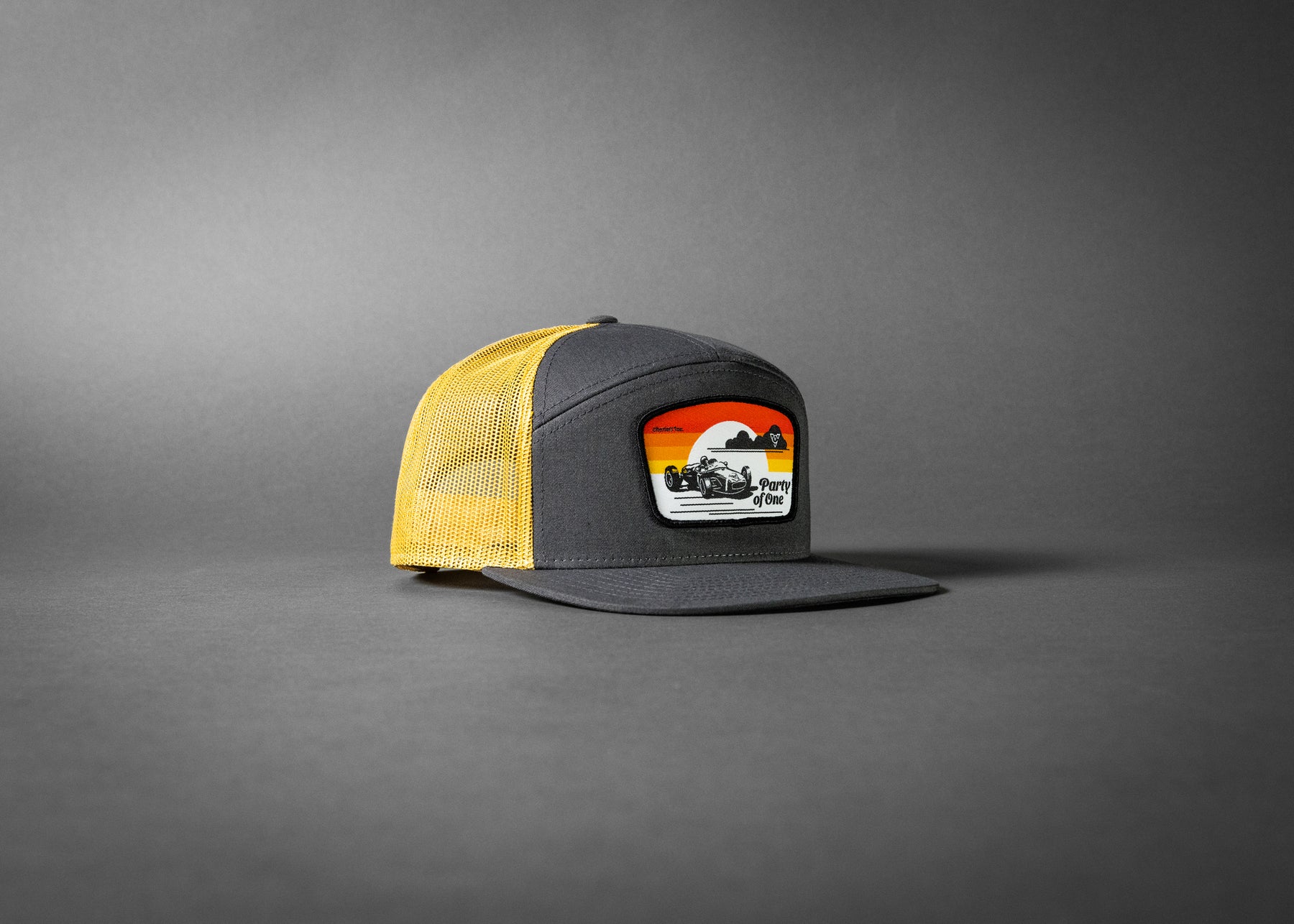 PARTY OF ONE (Charcoal/Old Gold Premium 7-Panel Trucker Hat)