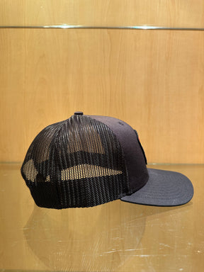 PARTY OF ONE (Black/Black Premium Trucker Hat)