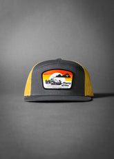 PARTY OF ONE (Charcoal/Old Gold Premium 7-Panel Trucker Hat)