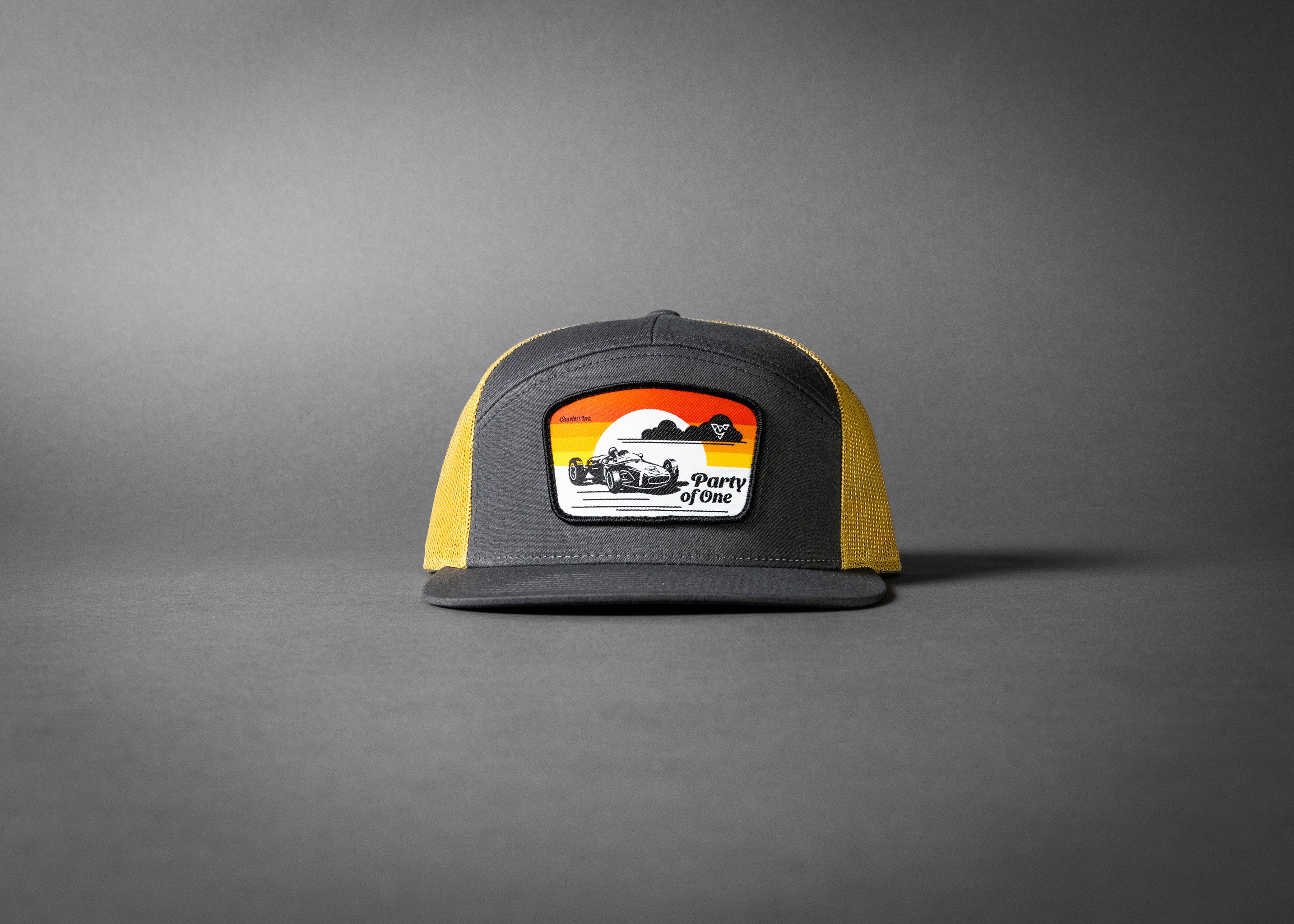 PARTY OF ONE (Charcoal/Old Gold Premium 7-Panel Trucker Hat)